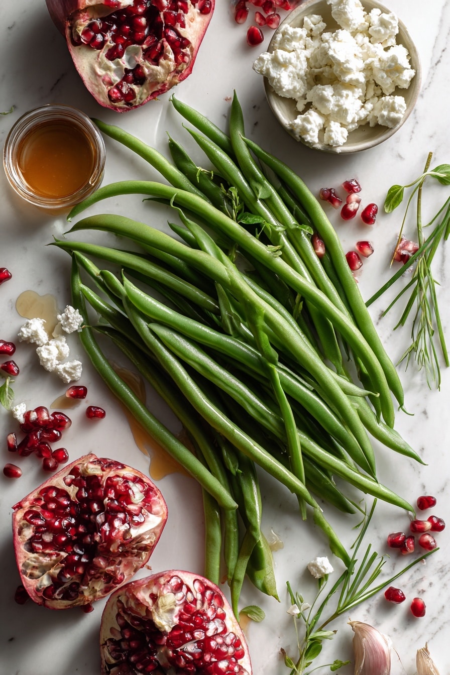 Flat lay of fresh bright green beans with their smooth pods and crisp texture, thinly sliced pale purple shallots showing delicate rings, vibrant ruby red pomegranate arils glistening like jewels, soft creamy white crumbled goat cheese with a slightly crumbly texture, small green sprigs of fresh chopped chives adding a touch of vivid green, a small pile of golden caramelized shallots with a glossy finish, and a small glass jar of amber-colored maple syrup with a rich, smooth surface, all beautifully arranged in a natural, slightly scattered composition, placed on white marbled surface, photo taken with an iphone --ar 2:3 --v 7 - Maple Mustard Green Beans with Pomegranate and Goat Cheese, healthy green bean side dish, spring green beans recipe, fruit and cheese salad, easy vegetable side dish